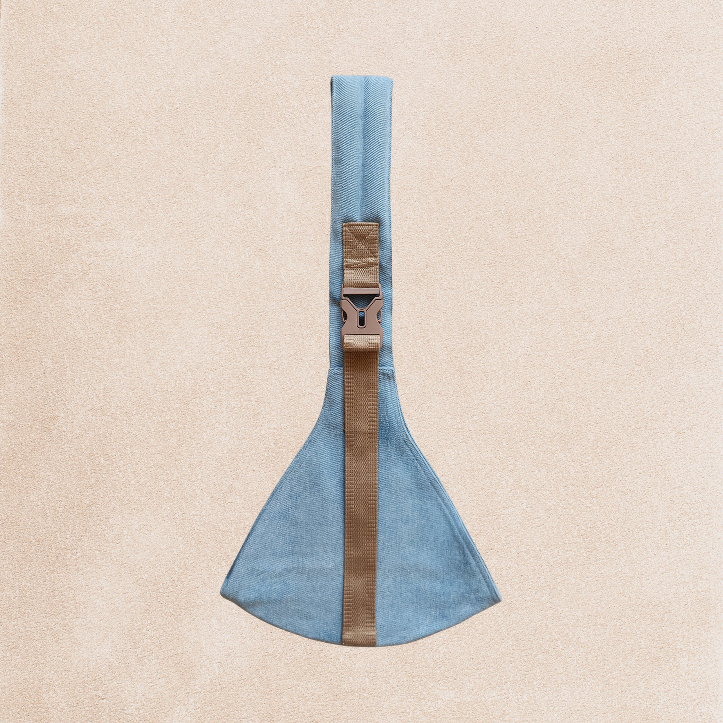 A denim blue toddler carrier with plastic buckles and cotton fabric, displayed against a neutral background.