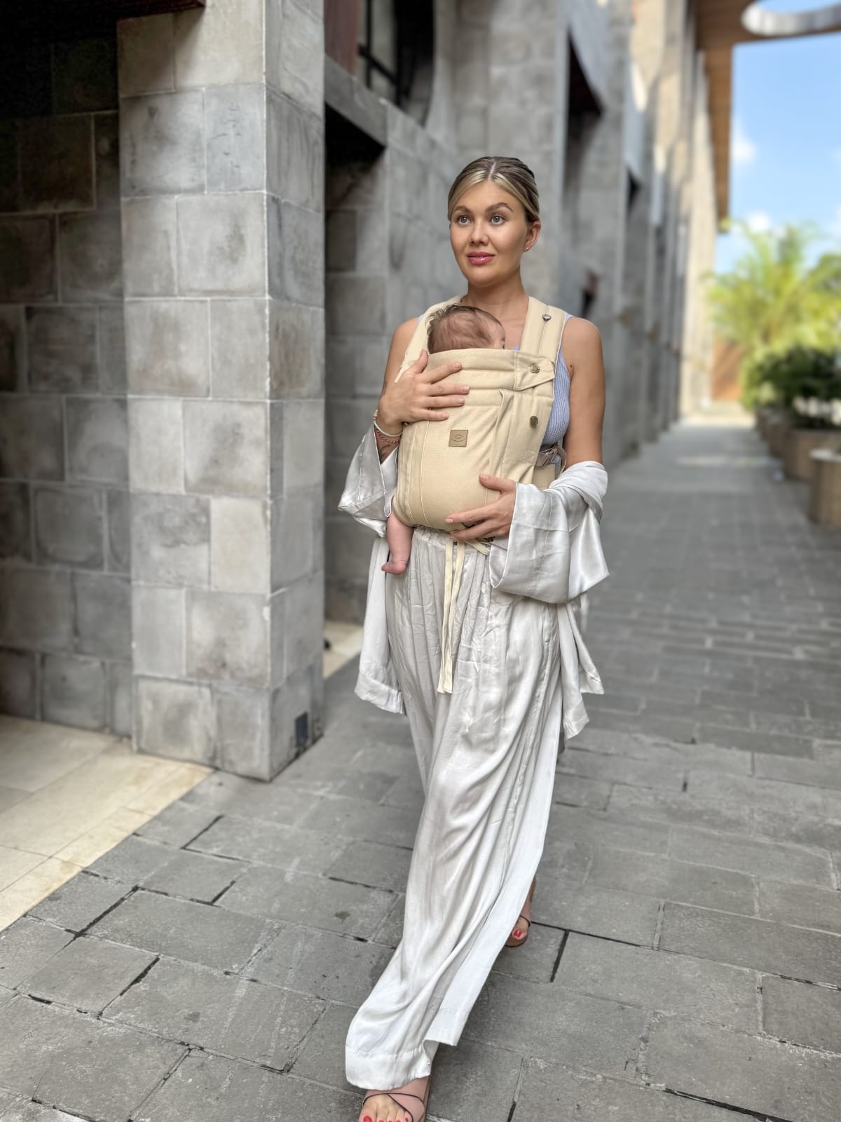 woman walking with baby wearing keep closer comfort fir baby carrier