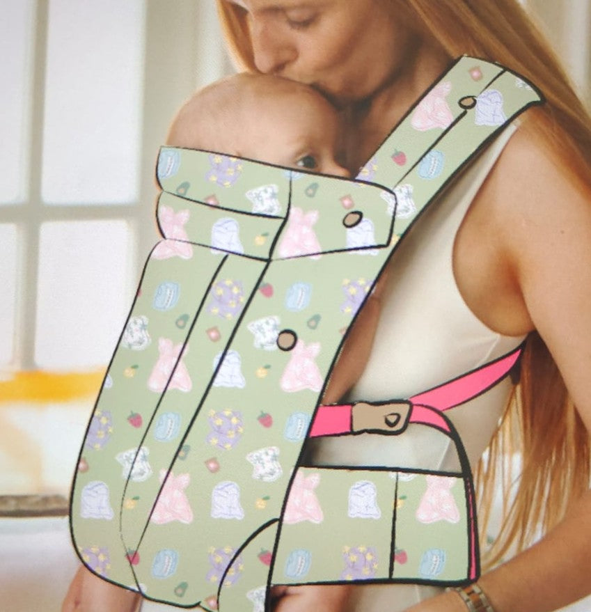 Woman holding a baby in a floral-patterned baby carrier.