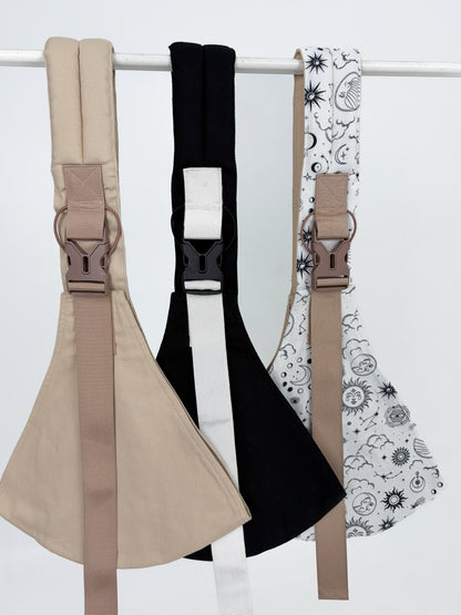 Keep Closer toddler hip carriers displayed in three colours: sand, black, and Sun and Moon print